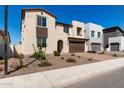 Charming two-story home featuring a brick driveway and a beautifully landscaped front yard at 18002 W Vogel Ave, Goodyear, AZ 85338