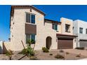 Charming two-story home featuring a brick driveway and a beautifully landscaped front yard at 18002 W Vogel Ave, Goodyear, AZ 85338