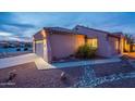 House exterior at dusk showcasing garage and walkway at 10364 E Second Water Trl, Gold Canyon, AZ 85118
