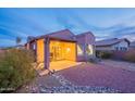 Evening view of a covered patio and backyard at 10364 E Second Water Trl, Gold Canyon, AZ 85118