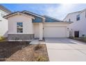 New construction home with two-tone exterior, attached garage, and landscaped front yard at 17993 W Long Lake Rd, Goodyear, AZ 85338