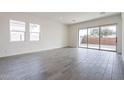Bright and spacious living room with tile floors and sliding glass doors leading to the backyard at 17993 W Long Lake Rd, Goodyear, AZ 85338