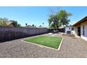 Large backyard with low-maintenance gravel, artificial grass, and outdoor seating area at 1531 W Plana Ave, Mesa, AZ 85202