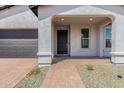 Covered front porch entryway with a dark brown door at 7386 W Bent Tree Dr, Peoria, AZ 85383