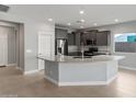 Bright kitchen featuring gray cabinets, stainless appliances and a granite breakfast bar at 2851 N Coronado Dr, Florence, AZ 85132