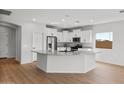 A well lit kitchen with stainless steel appliances, granite countertops, and white cabinetry at 2868 N Coronado Dr, Florence, AZ 85132