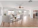 Bright, open living room with a ceiling fan, neutral tones, and sliding glass doors to the back yard at 31777 N Sundown Dr, San Tan Valley, AZ 85143