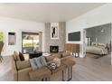 Virtually staged living room with fireplace and view into bedroom at 4062 E Round Hill Dr, Phoenix, AZ 85028