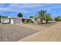 Single story home with attached garage and palm trees at 5502 E Billings St, Mesa, AZ 85205