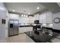 Modern kitchen features stainless steel appliances and dark granite countertops at 28959 N 124Th Ave, Peoria, AZ 85383