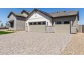 Front exterior view features a multi-car garage, stone and siding accents, and a paved driveway at 1606 E Minton St, Mesa, AZ 85203