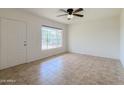 Open living room with tile flooring, a bright window, and a ceiling fan for added comfort at 634 S Pasadena --, Mesa, AZ 85210