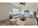 Bright living room featuring tile flooring, comfortable seating, and a large window for natural light at 634 S Pasadena --, Mesa, AZ 85210