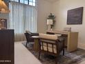 Comfortable home office with modern desk, chairs, and ample natural light from a large window at 8 E Biltmore Est # 109, Phoenix, AZ 85016