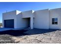 Newly built home features a gray garage door and clean lines at 22205 W Ocupado Dr, Wittmann, AZ 85361
