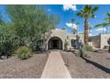 Brick pathway to the entrance of this beautiful home with mature landscaping at 8044 E Del Mercurio Dr, Scottsdale, AZ 85258