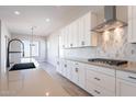 Bright kitchen boasts white cabinets, center island, and stylish fixtures at 20252 W Catalina Dr, Buckeye, AZ 85396