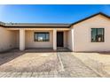 Inviting front porch with elegant columns and a paved walkway at 22750 E Roper Ln, Florence, AZ 85132