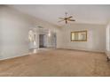 Bright living room with a large mirror and ceiling fan at 25809 S Hollygreen Dr, Sun Lakes, AZ 85248