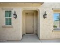 Inviting front entrance with decorative sconces and an arched entryway at 19591 W Lincoln St, Buckeye, AZ 85326