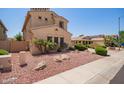 Side view of a stucco home featuring desert landscaping and a tile roof at 15115 W Cottonwood St, Surprise, AZ 85374