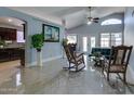 Bright and spacious living room with rocking chairs and access to the backyard at 8976 W Stella Ave, Glendale, AZ 85305