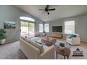 Bright and airy living room with sliding glass doors leading to the backyard and pool at 3128 E Millbrae Ln, Gilbert, AZ 85234
