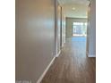 Inviting hallway featuring wood-look tile flooring and an arched entryway to the living area at 10015 W Verde Ln, Avondale, AZ 85392