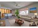 Spacious living room with large window, tiled floors, and contemporary furniture at 2104 N Olive Ave, Mesa, AZ 85203