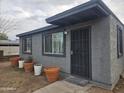 Gray house with a security door and several potted plants at 2209 E Sheridan St, Phoenix, AZ 85006