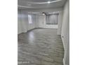 Spacious living room with gray tile floor and ceiling fan at 2209 E Sheridan St, Phoenix, AZ 85006