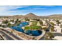 Community overview with lake, golf course, and surrounding houses at 21956 N 59Th Ln, Glendale, AZ 85310