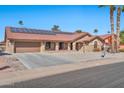 Single-story home with solar panels and a two-car garage at 18822 N Grandview Dr, Sun City West, AZ 85375