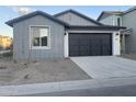 Exterior view of a two-car garage with a dark garage door and a concrete driveway at 4505 S Mole --, Mesa, AZ 85212