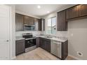 Modern kitchen featuring dark wood cabinets and granite countertops at 1291 W Treasure Trl, Apache Junction, AZ 85120