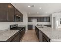 Modern kitchen with granite countertops and dark brown cabinets at 1449 W Saddle Run, Apache Junction, AZ 85120