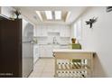 Bright kitchen featuring white cabinets, stainless steel refrigerator, and a skylight at 15601 N 27Th St # 7, Phoenix, AZ 85032