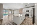 Modern kitchen with white cabinets and large island at 41432 N Bent Creek Way, Phoenix, AZ 85086