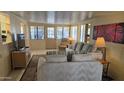 Bright living room featuring neutral tones, a plush sofa, and ample natural light at 17200 W Bell Rd # 569, Surprise, AZ 85374