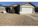 House exterior featuring a gray color scheme and a two-car garage at 1244 E Desert Rose Trl, San Tan Valley, AZ 85143