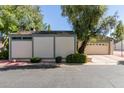 Exterior view of an attached home, featuring neutral stucco and trimmed with green paint at 8101 N Central Ave # 6, Phoenix, AZ 85020