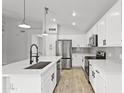 Modern kitchen with white cabinetry, stainless steel appliances, and a large center island at 2390 S Walnut Dr, Chandler, AZ 85286