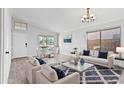 Bright living room with stylish furniture, wood-look tile floors and lots of natural light at 2390 S Walnut Dr, Chandler, AZ 85286