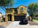 Two-story house with Spanish-style architecture, a two-car garage, and a landscaped front yard at 7213 S 12Th Pl, Phoenix, AZ 85042