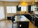 Spacious kitchen with granite countertops and dark cabinetry at 7213 S 12Th Pl, Phoenix, AZ 85042