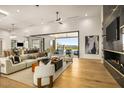 Bright, open living room featuring a modern fireplace, beautiful hardwood floors, and mountain views at 36323 N 100Th Way, Scottsdale, AZ 85262