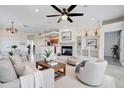 Bright and airy living room with a fireplace, built-in shelves, and an open floor plan to the kitchen at 11500 E Cochise Dr # 2090, Scottsdale, AZ 85259