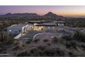 Modern home with a curved driveway and mountain backdrop at 28805 N 114Th St, Scottsdale, AZ 85262