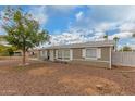 Charming single-story home with desert landscaping, shade tree, and cozy front entrance at 244 N Hawes Rd, Mesa, AZ 85207