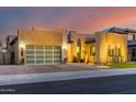 Stunning modern home with a landscaped front yard and large glass garage door at 9503 W Jj Ranch Rd, Peoria, AZ 85383